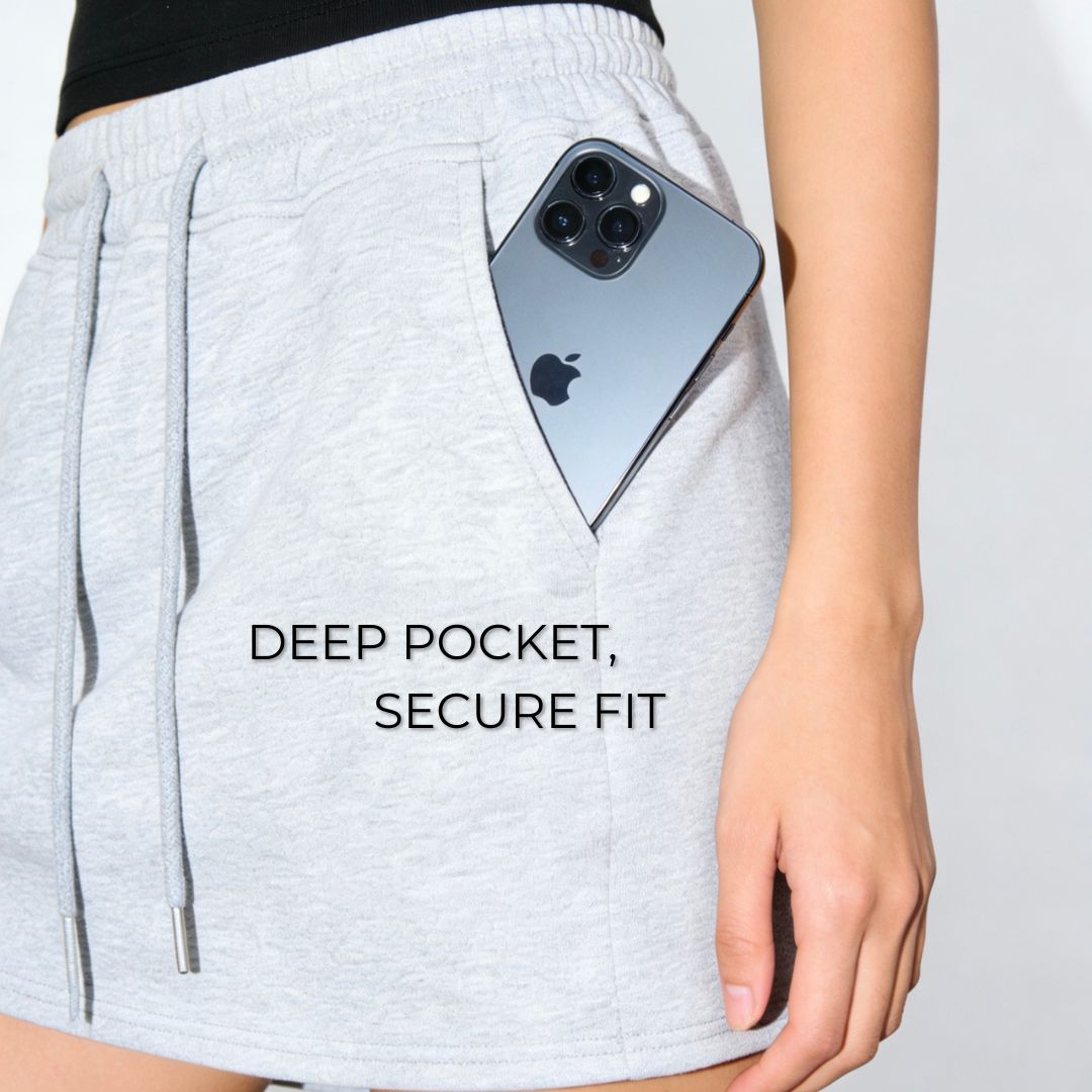Person wearing light gray shorts with a phone in a pocket, text 'DEEP POCKET, SECURE FIT' on a white background